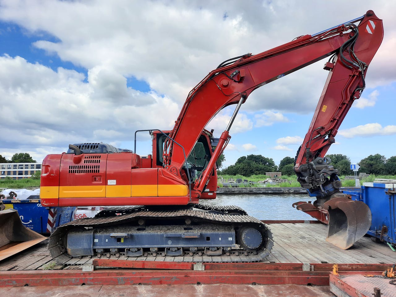 our-services-3 Red excavator parked on a riverside construction site in Nederland.